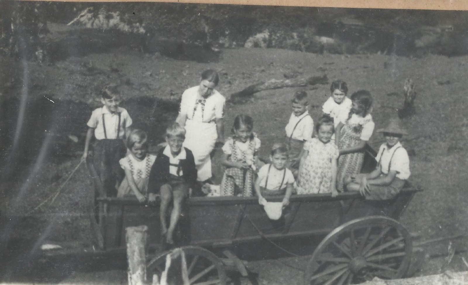 Crianças da família Prost sobre uma carroça de madeira